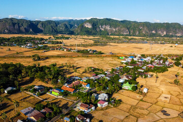 Photos of views of villages and rice fields during the dry season are displayed