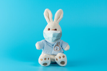 Obraz premium Creative composition with cute bunny doll with virus mask. Minimal Corona virus outbreak. Holiday concept.