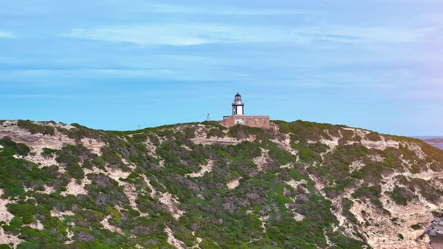 Exploring the historic lighthouse on a scenic cliff at Cape Cod during a clear sunny afternoon in late summer with breathtaking coastal views and lush greenery