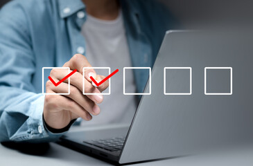 Businessman use pen to tick correct sign mark in checkbox for quality document control checklist...