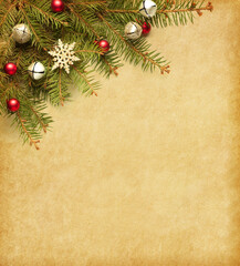Fir branch with Christmas decorations on old yellowed paper background.. Flat lay.  Vintage Christmas and New Year holidays background...