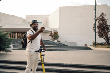Smiling delivery man taking selfie on scooter in city © Ljustina