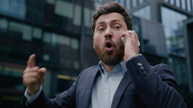 Annoyed mad crazy business man angry furious Caucasian businessman guy male boss employer aggressive irritated talk mobile phone shout scream yell cellphone conflict in city quarrel rage argue outdoor