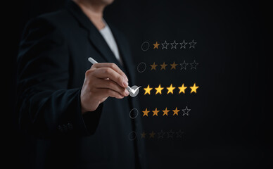 businessman uses stylus pen to give a 5-star rating, satisfaction and appreciation for services highlights the importance of excellent service and positive customer feedback	
