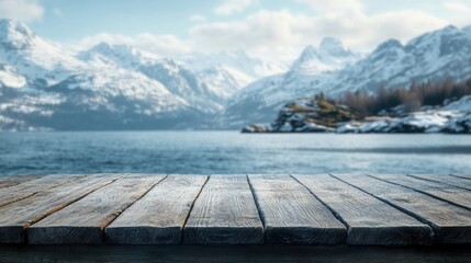 Rustic wooden table with cold sea and snow capped mountains in the background ideal for winter product display Features ample copy space for your text