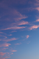 Onslaught of Dusk - Light Pink Colored Clouds Feather the Clear Blue Sky as Evening Approaches