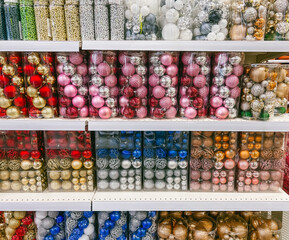Colorful Christmas balls in a store. Christmas decorations for sale. Christmas decor in the supermarket.