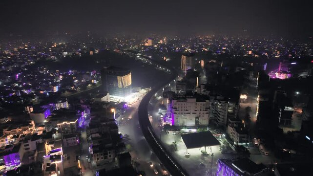 aerial drone shot flying backward over jaipur, indore, Ahmedabad, chandigarh city showing fireworks with metro train on elevated track decorated with lights on the eve of diwali makar sankranti