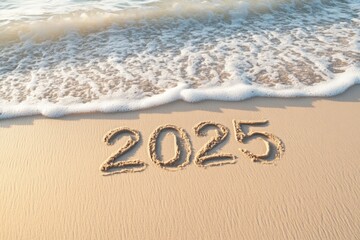 Fototapeta premium 2025 written in sand with ocean waves in the background on a sunny beach