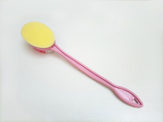 Bath brush made of plastic on laying its back on white background, hygiene care shower brush with handle