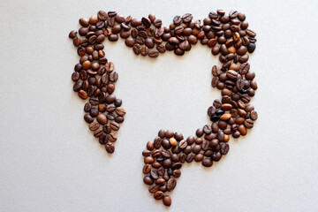 Intestines shape made of coffee beans, impact of coffee on bowels health, creative concept