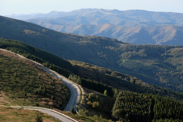 Asphalt road leading through a hilly landscape in Bulgaria