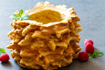 Lithuanian sakotis or Polish sękacz, traditional tree cake decorated with raspberries and mint