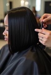 Fototapeta premium A stylist cuts a woman's hair in a salon