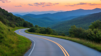 Beautiful mountain road with green grass at sunset