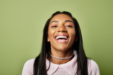 A cheerful young woman showcases her warm autumn style, radiating joy and confidence amidst colors.
