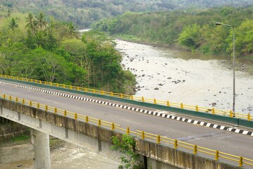 A highway road bridge on a river in the mountains