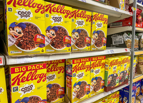 Packets of Kellogg cereal products displayed on shelves of a supermarket. Kellogg's is an American multinational food manufacturing company.