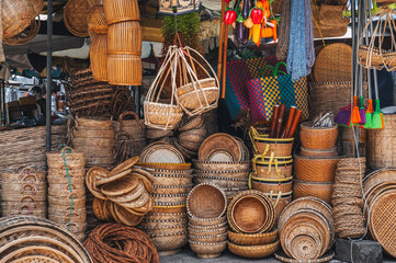 A set of handmade traditional Asian baskets made of straw and natural fiber for sale at the outdoor market in Nha Trang
