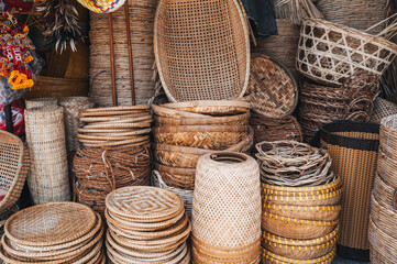 Traditional Asian rattan wicker baskets and containers on the counter at the Asian street market