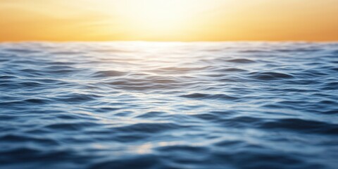 Obraz premium Beautiful ocean waves reflecting the warm sunset hues, creating a serene and calming atmosphere.