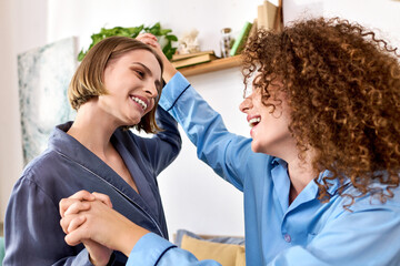 Obraz premium A beautiful young couple enjoys each others company, sharing smiles and playful moments at home.