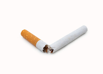 Closeup of a broken cigarette on a white background.