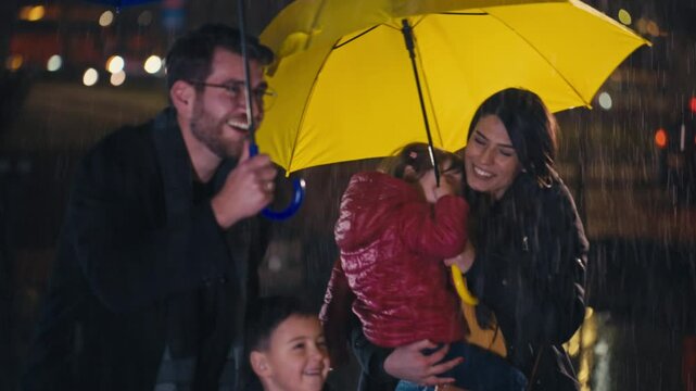 Family smiling and sharing umbrellas in the rain at night, creating a joyful moment together despite the weather. Concept of family bonding, resilience, and happiness in challenging conditions