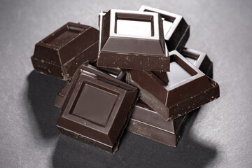 Pieces of chocolate on dark background