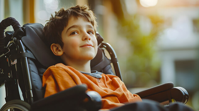 Cheerful young boy with cerebral palsy in wheelchair. Celebrating life for World Cerebral Palsy Day