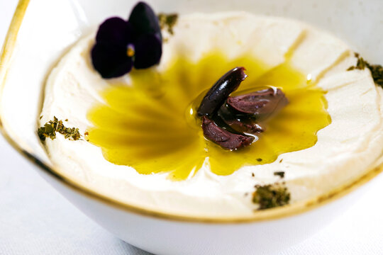 Labneh served in a small bowl on a white countertop.