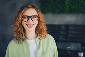 Photo of young hacker programmer girl toothy smile braces wear shirt workstation loft office indoors