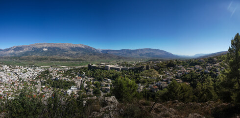 wide panorama of city Gjirokastra, albania, with castle in center and blue sky