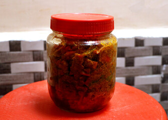 Homemade north indian spicy carrot pickle on a rustic background