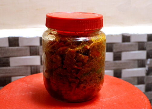 Homemade north indian spicy carrot pickle on a rustic background