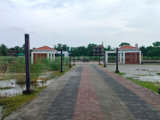 a walkway with a bridge and a few gazebos