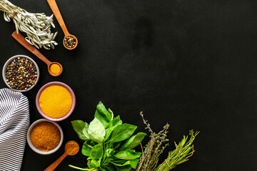 Colorful herbs and spices for cooking on cooking desk, top view