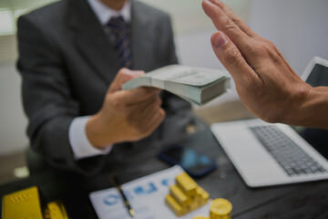 Fototapeta premium An Asian male gold investor strategically allocates resources into gold to build wealth and diversify his portfolio. He analyzes market trends, seeks opportunities, and prioritizes financial security
