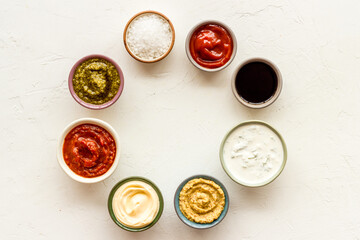 Many different sauces in bowls. Food or cooking background