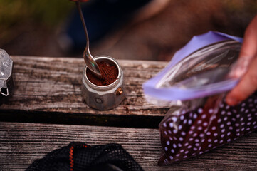 Adding Coffee Grounds to Moka Pot for Outdoor Brewing