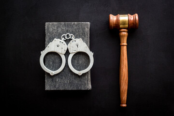 Judges gavel and police metal handcuffs, top view. Criminal offense and detention concept