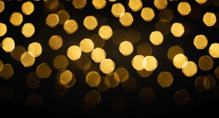 Obraz premium golden bokeh effect like shimmering stars with black background