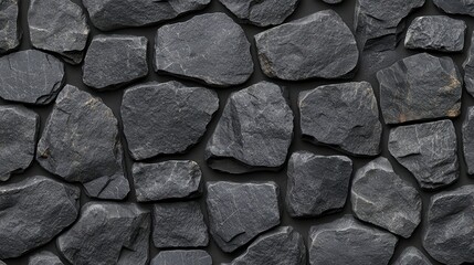 Fototapeta premium A textured display of dark gray stones arranged seamlessly, creating a natural and rustic background.
