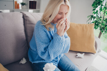 Portrait of nice aged lady sit sofa blow nose napkin wear sweater pastime weekend modern flat...