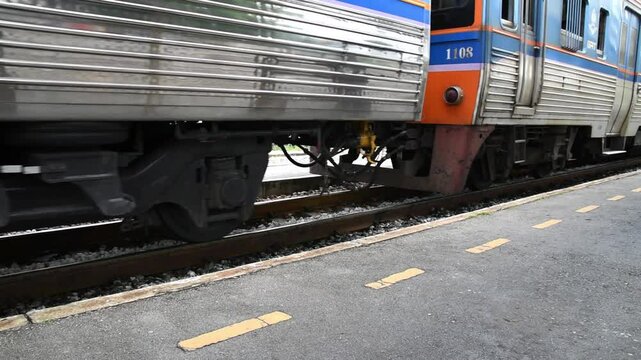 train moving from station, safety line border marking on platform edge