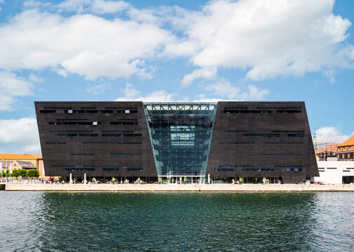 Copenhagen, Denmark - July 18, 2024: Front view of the southern facade of the Black Diamond building by Danish architects Schmidt Hammer Lassen, built in 1999 to extend the Royal Library.