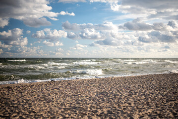 The coastline of the Baltic Sea in northern Poland features stunning sandy beaches, picturesque dunes, and lush greenery, offering a serene escape for nature lovers and beachgoers.