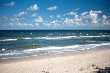 The coastline of the Baltic Sea in northern Poland features stunning sandy beaches, picturesque dunes, and lush greenery, offering a serene escape for nature lovers and beachgoers.
