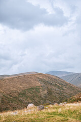 Dramatic mountain valley under a cloudy sky with a rugged landscape