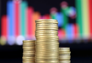 View from behind a stack of coins creating a bokeh effect
